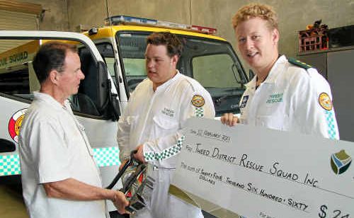 Tweed Mayor Kevin Skinner hands over the cheque to Tweed District Rescue Squad operator Jeremy Reay and president Jamie Stoddart. Tweed Mayor Kevin Skinner hands over the cheque to Tweed District Rescue Squad operator Jeremy Reay and president Jamie Stoddart.